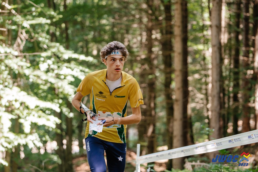 David Stocks orienteering through a forest while representing Australia at the Junior World Orienteering Championships 2023.