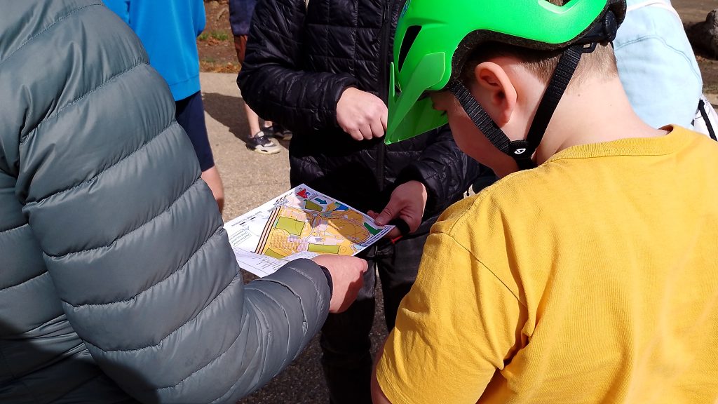 Orienteering participants looking at a map