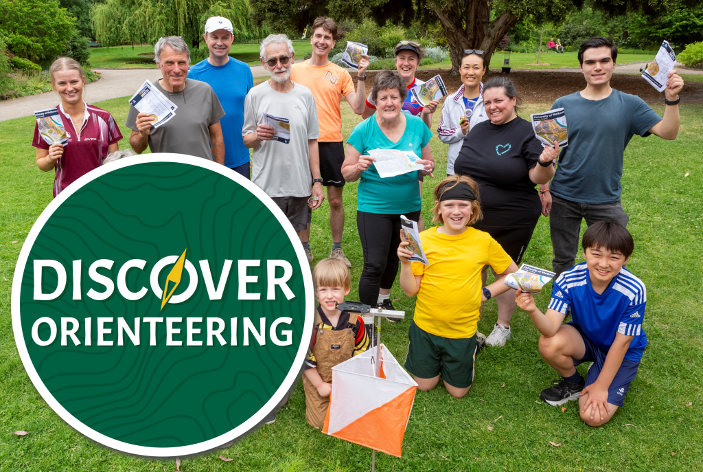 Explore Hero 3 - Orienteering Australia - Orienteering Australia Discover Orienteering logo in front of a photo of participants posing for the camera holding maps up